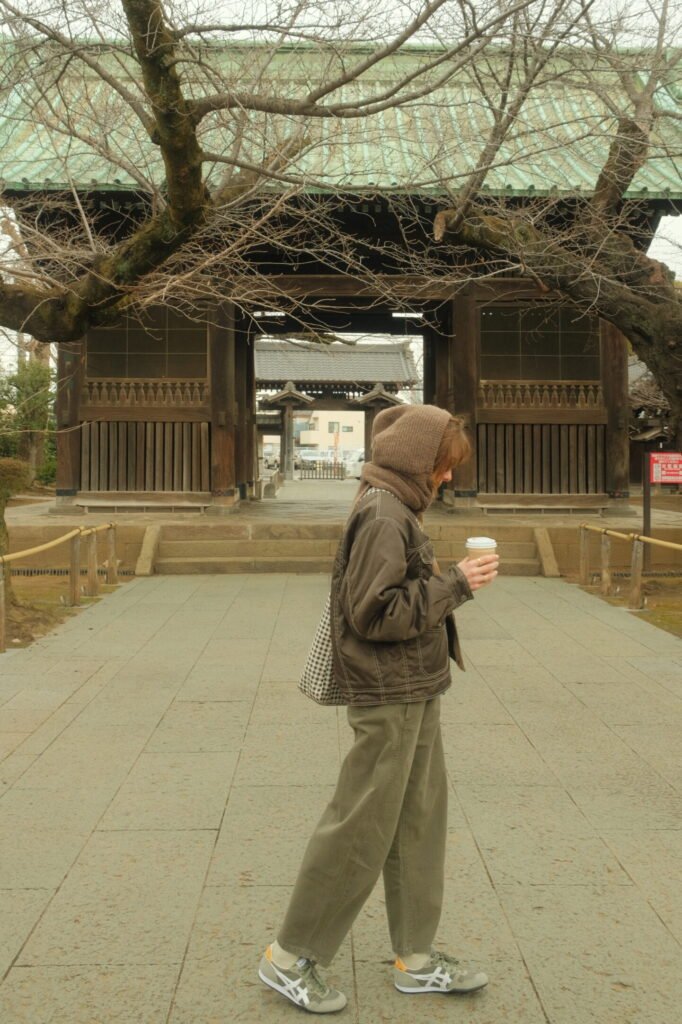 Woman walking in front of shrine - Tokyo, Japan