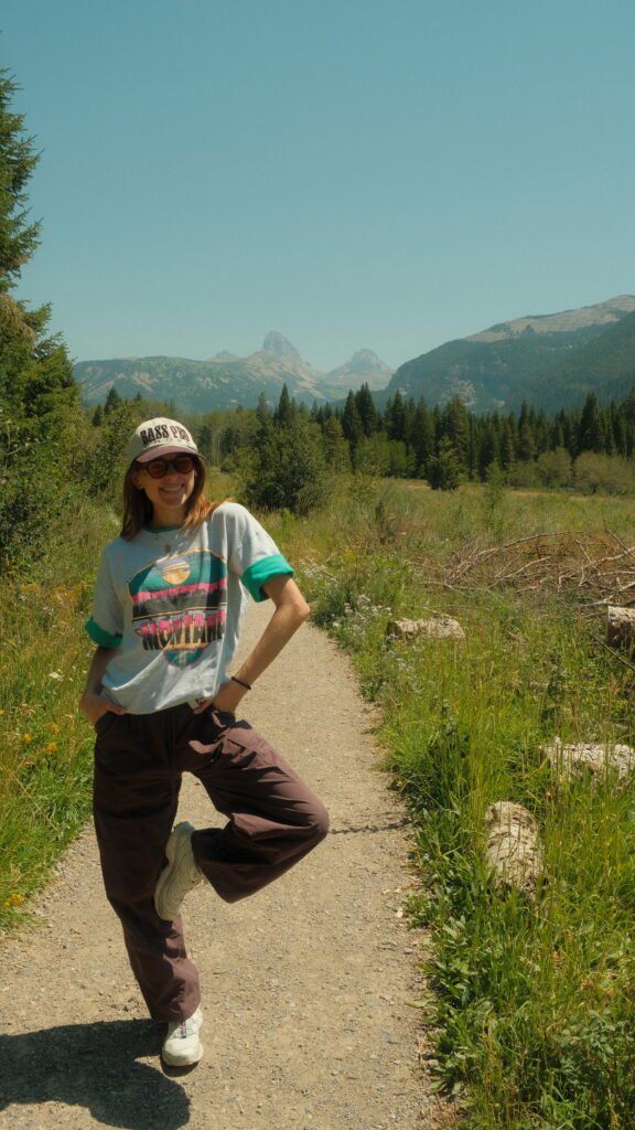 Woman standing in front of Teton mountain range near Driggs, Idaho 