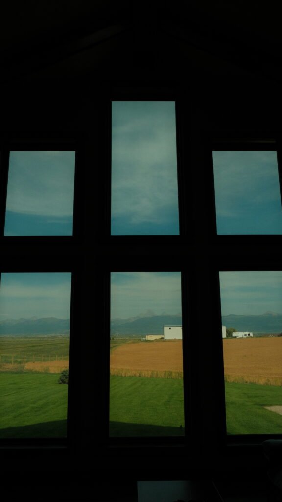 Field and mountain view from inside the Airbnb in Driggs, Idaho