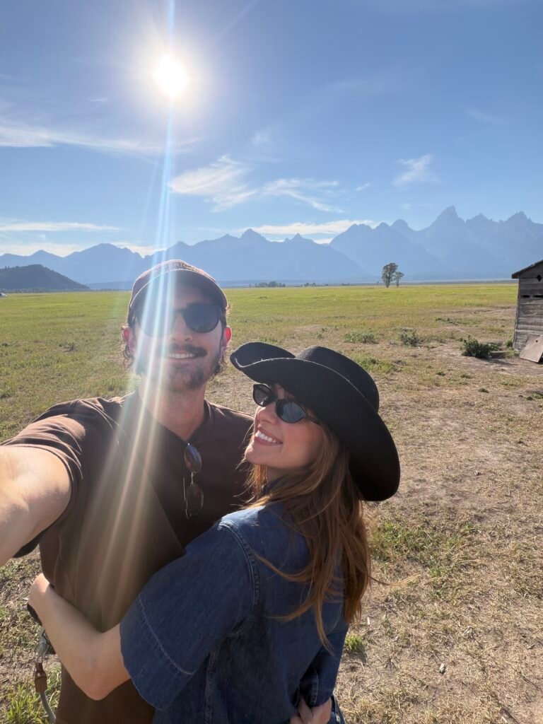 Man and woman hugging at Mormon Row in Grand Teton National Park, Wyoming