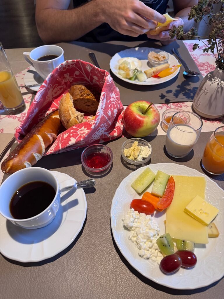 A morning breakfast spread of bread, fruit, and coffee at our hotel near Füssen