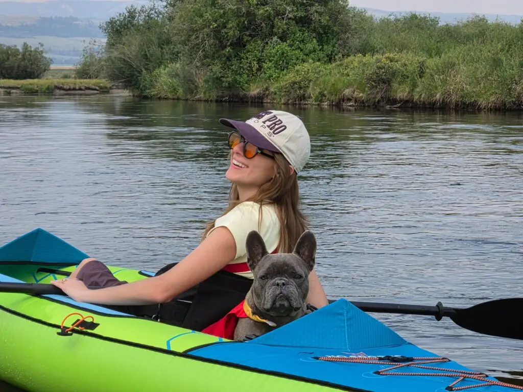 Woman and dog in a kayak on the Teton River in Driggs, Idaho