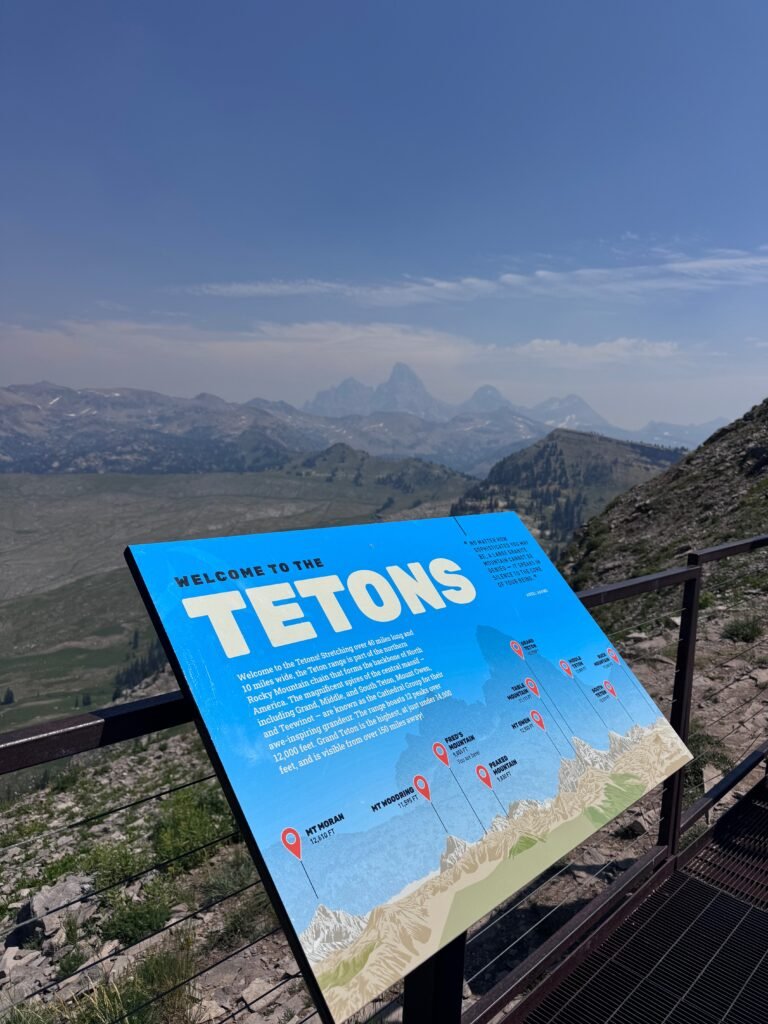 Sign in front of the Teton mountain range at Grand Targhee Resort
