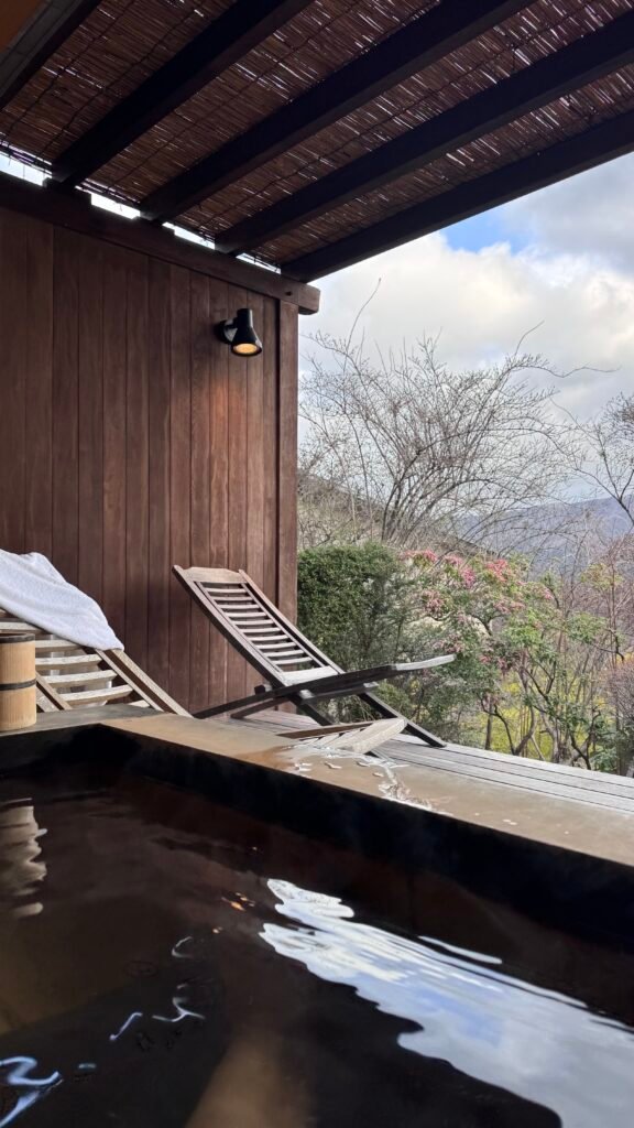onsen and chairs overlooking the tress and mountains at a ryokan in Hakone, Japan