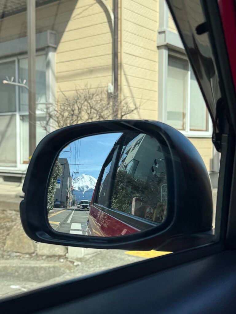 Car mirror with a view of Mount Fuji in Japan