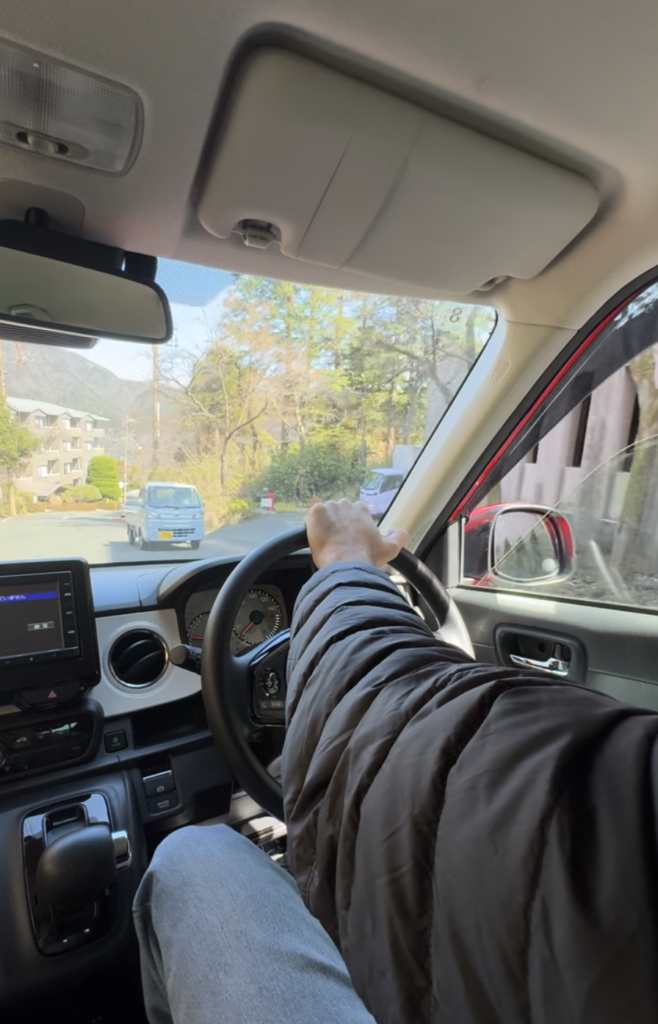 Man's hand on steering wheel, Hakone Japan