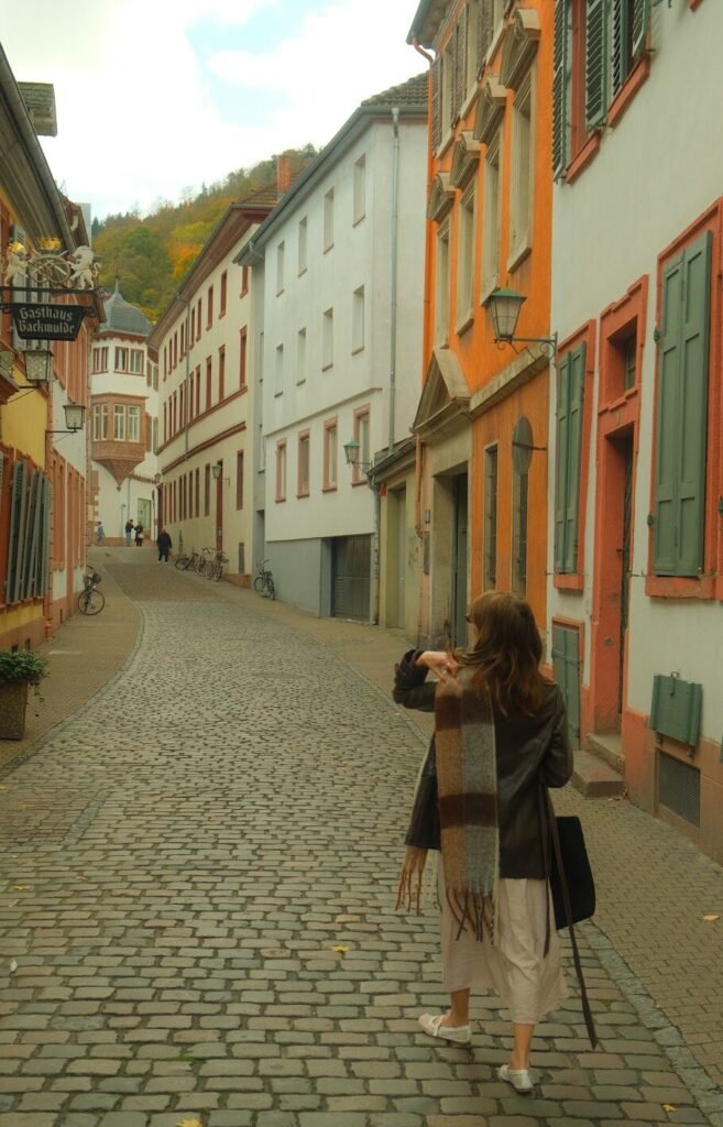 Woman walking down a street in Heidelberg, Germany